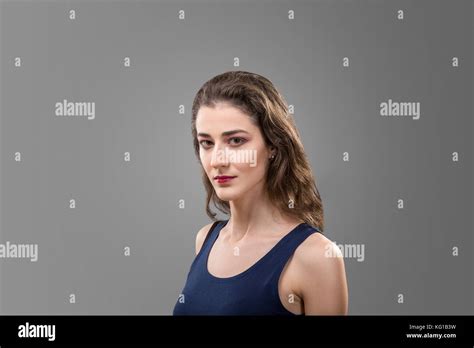 Studio Portrait Of Brunette Woman Isolated Over Gray Background Stock