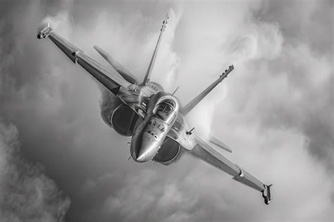 Premium Photo A Fighter Jet Flying Through A Cloudy Sky