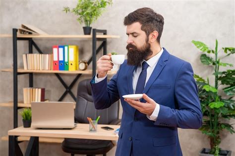 Premium Photo Mature Entrepreneur In Jacket Having Coffee Break At