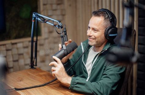 Portrait Of Mature Radio Host Speaking In Microphone While Moderating A