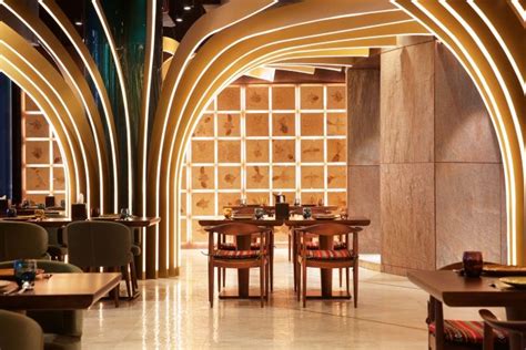 The Interior Of A Restaurant With Wooden Tables And Chairs In Front Of