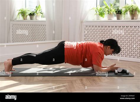Overweight Mature Woman Doing Plank Exercise At Home Stock Photo Alamy