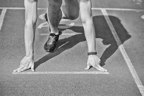 Man Runner With Muscular Hands Legs Start On Running Track Stock Image