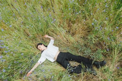 Premium Photo | Beautiful girl among the summer field with wildflowers