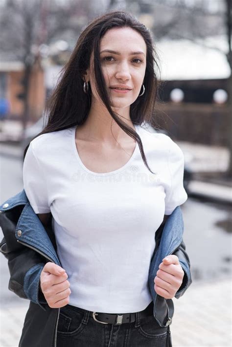 Portrait Of A Beautiful Brunette Girl Who Poses While Walking On The Street Stock Photo Image