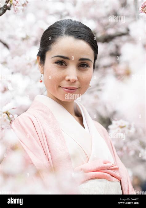 Portrait Of Young Japanese Woman Wearing Kimono With Cherry Blossom In