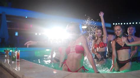 Pretty Woman In Bikini Dancing And Hanging Out With Friends At Night Pool Party People Having