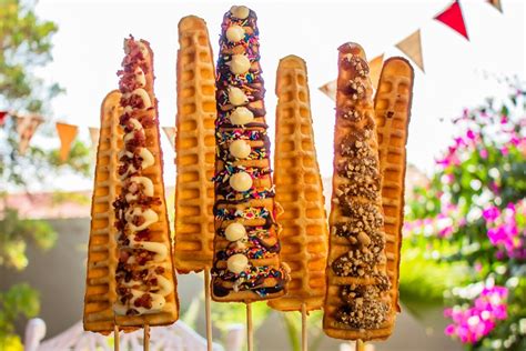 There Are Many Waffles On The Stick With Toppings And Sprinkles