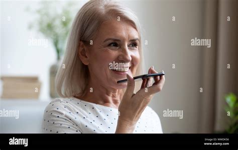 Smiling Mature Woman Recording Voice Message On Phone Close Up Stock