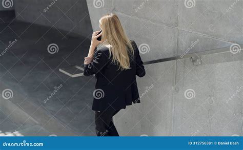 Professional Woman Talking On Phone In Modern Setting Stock Image