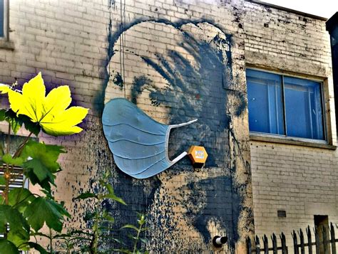 Face Mask Appears on Banksy’s Mural ‘Girl With a Pierced Eardrum’