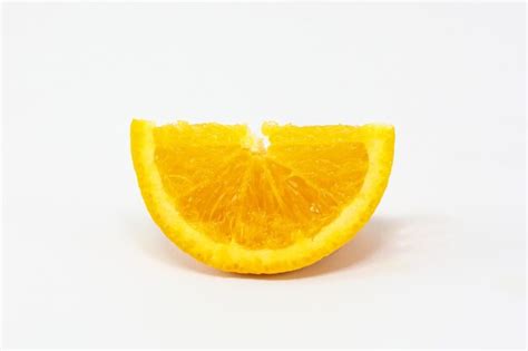 Premium Photo Close Up Of Orange Slice Against White Background