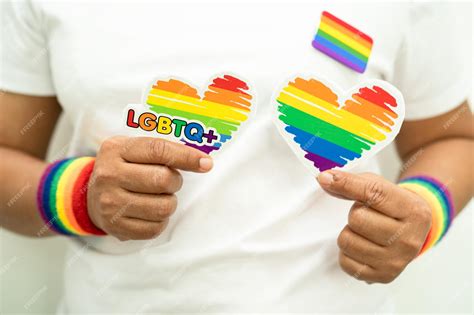 Premium Photo Asian Lady Wearing Rainbow Flag Wristbands And Hold