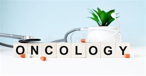 The Word Oncology Is Written On Wooden Cubes Near A Stethoscope On A