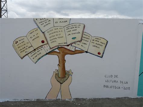 A Mural On The Side Of A Building Depicting A Tree With Many Books In It