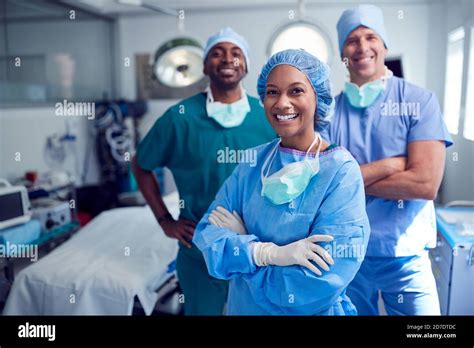 Portrait Of Multi Cultural Surgical Team Standing In Hospital Operating