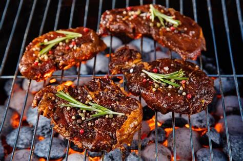 Beef Steaks On The Grill Grate With Fiery Coals Premium AI Generated