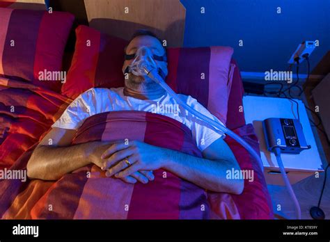 A Man With Sleep Apnea Syndrome Wears A Cpap Mask While Sleeping