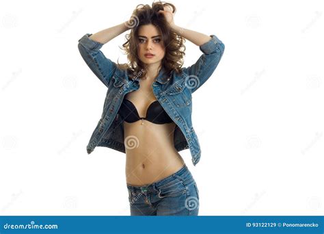 Beautiful Wonderful Brunette In Bra And Jeans Jacket Look At Camera And Keeps Hands Hair Stock