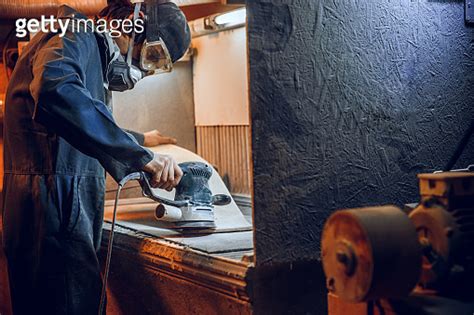 Carpenter Using Circular Saw For Cutting Wooden Boards