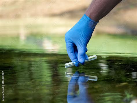 Water Sample Hand In Glove Collects Water In A Test Tube Concept