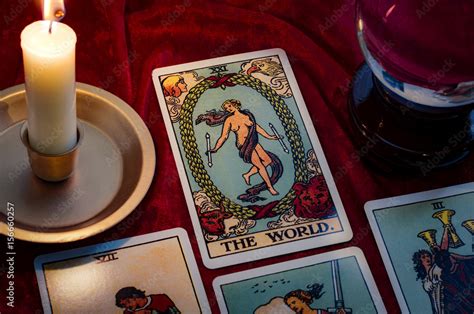 The World Tarot Card And Crystal Ball Under Candle Light Cartomancy Is