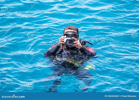 Underwater Photographer Videographer Scuba Dives on Surface of Sea ...