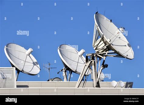 Satellite Communications Dishes On A Roof Stock Photo Alamy