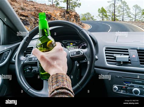 Drunk Young Man Driving A Car On The Road With A Bottle Of Beer Dont Drink And Drive Drunk