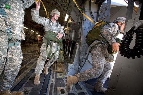 Army Paratroopers Jump From A C Globemaster Iii Aircraft During An