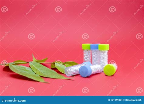 Sugar Globules Bottles Of Homeopathic Medicine With Green Leaf And Pink