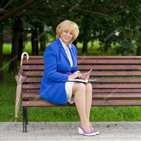 Mature Business Woman In A Jacket With Diary Sitting On A Bench Stock Photo Arkusha