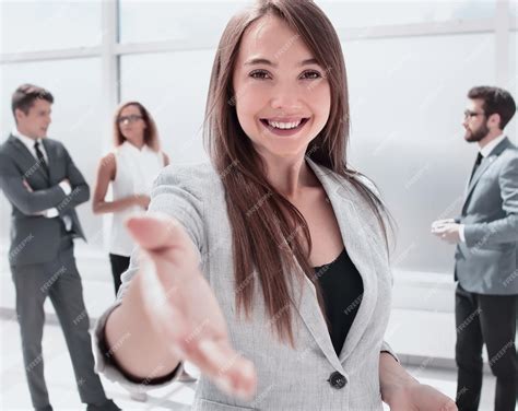 Premium Photo Young Business Woman Holding Out Her Hand For A Handshake