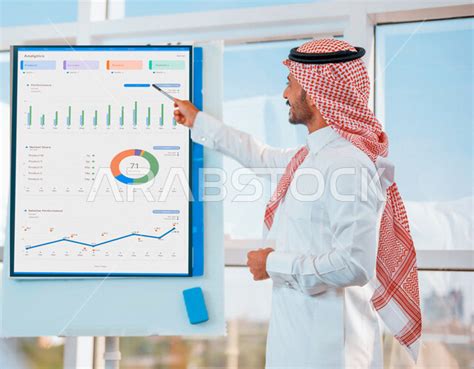 A Saudi Arabian Gulf Businessman At His Workplace Explaining Project