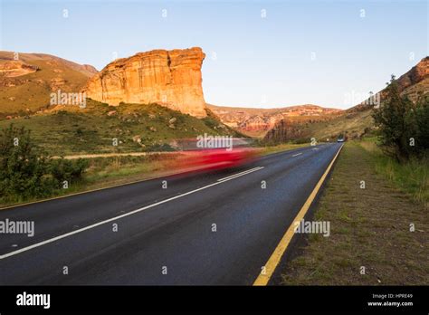 A Car Speeds By Brandwag Buttress Monument In Golden Gate Highlands