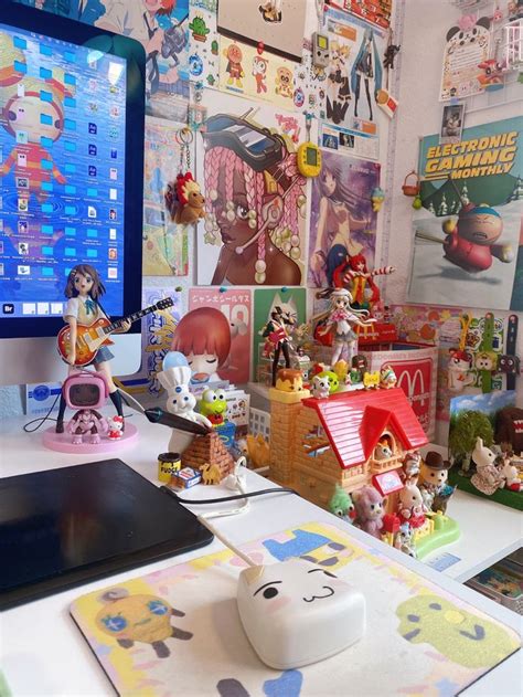 A Computer Monitor Sitting On Top Of A Desk Next To A Bunch Of Toy