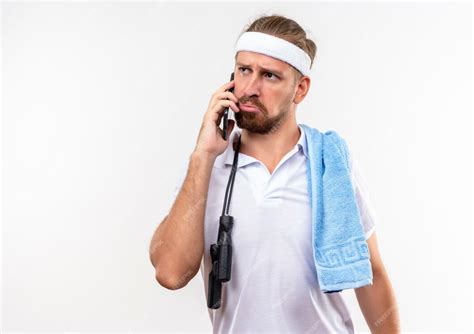 Free Photo Confused Young Handsome Sporty Man Wearing Headband And