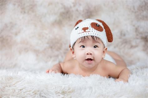 Premium Photo | Funny cute baby wearing knit a dog costume.