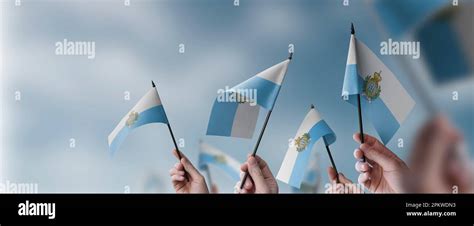 A Group Of People Holding Small Flags Of The San Marino In Their Hands