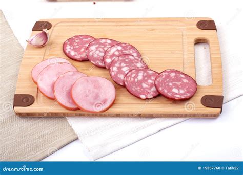 Salami Slicing Next To Garlic Stock Photo - Image of garlic, salami ...