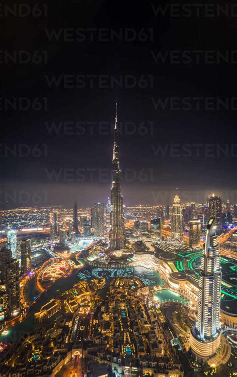 Aerial view of Burj Khalifa Tower and skyscrapers at night in Dubai, UAE. stock photo