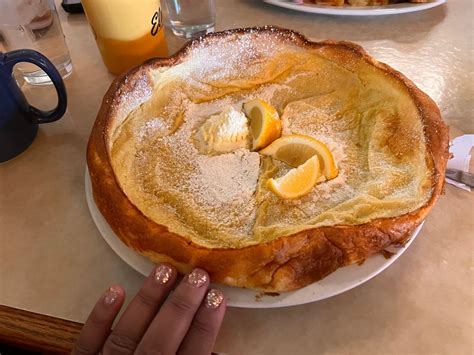 A Person Holding A Plate With Food On It