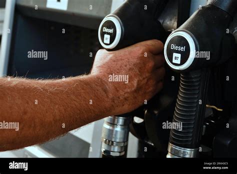 Refueling The Car A Mans Hand Refills Diesel Fuel At The Gas Station