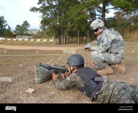 A Georgia Army National Guardsman Coaches A Soldier With The Guatemalan