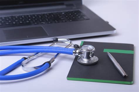 Workplace Of Doctor With Laptop Stethoscope And Notebook On White