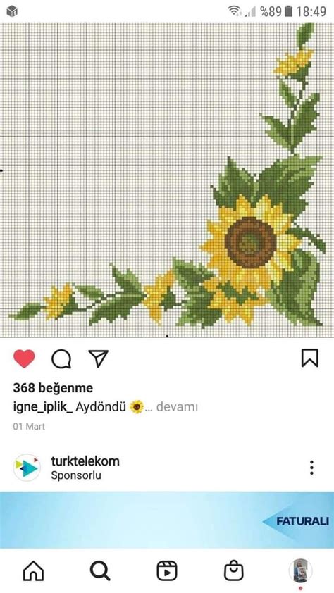 A Cross Stitch Sunflower With Green Leaves