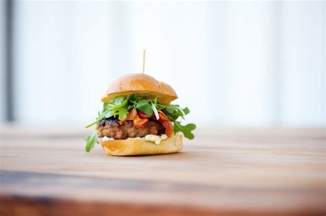 Premium Photo Bacon Cheeseburger On Brioche Bun With Arugula