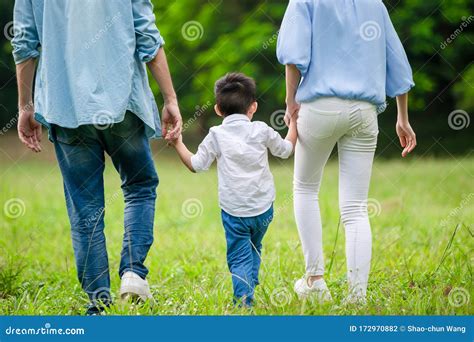 Young Parents Walking with Kid Stock Photo - Image of hold, family ...