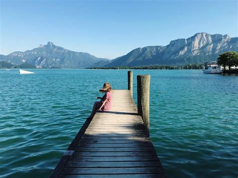 Premium Photo Rear View Of Woman On Pier Over Lake Against Sky