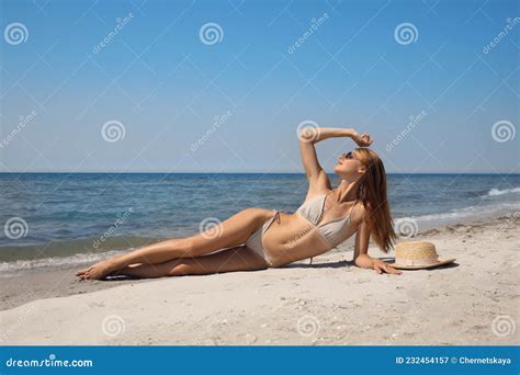 Attractive Woman With Perfect Body In Bikini Lying On Sandy Beach Near